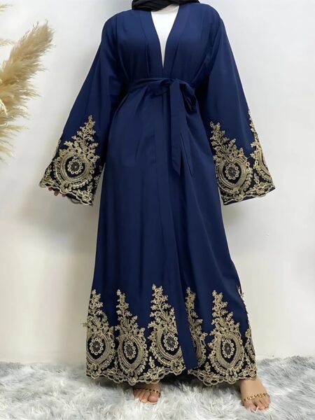 Femme portant une abaya dubaï luxe coloris bleu nuit avec des broderies sur fond blanc